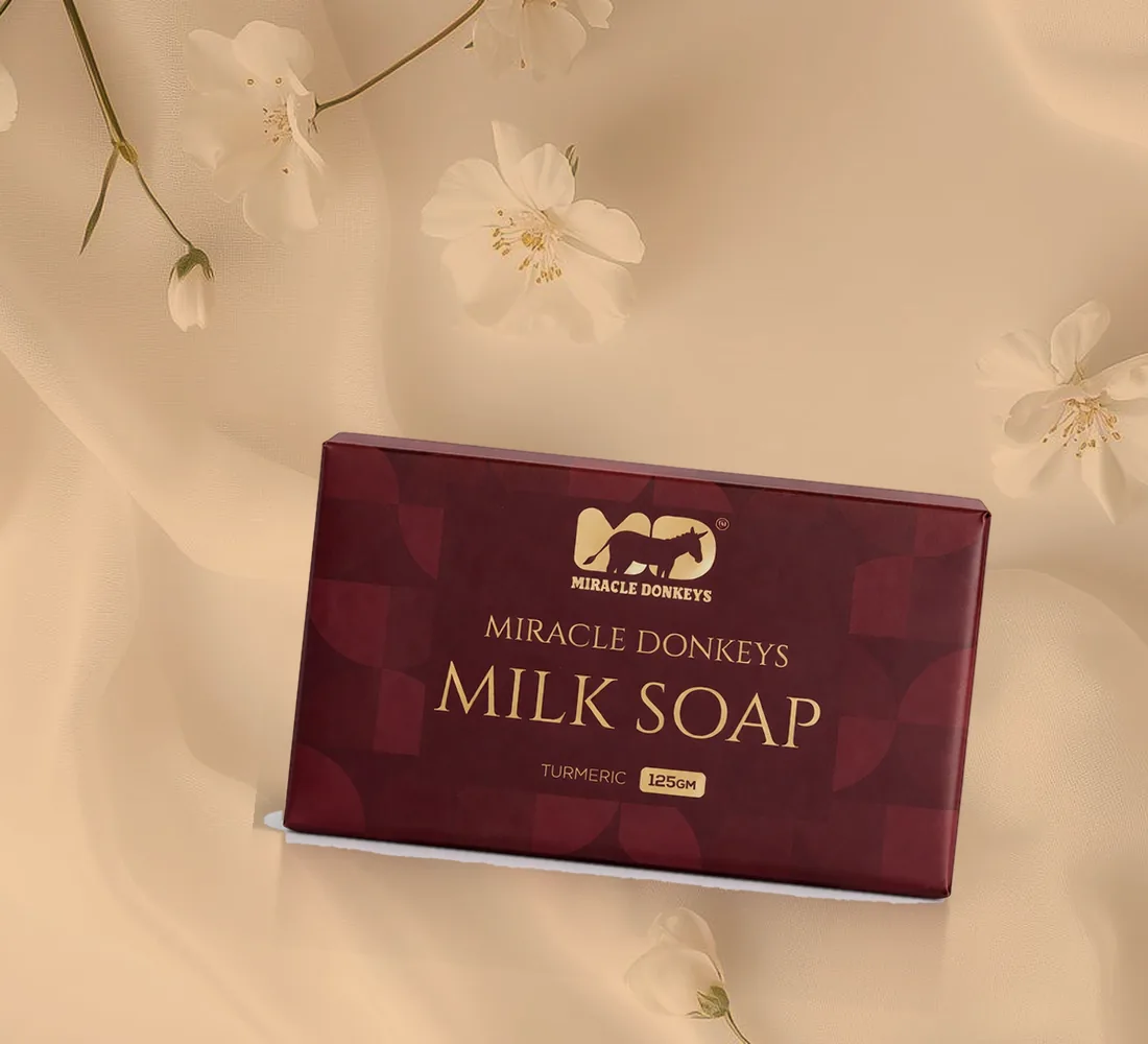 Turmeric donkey milk soap pack on warm-toned silk