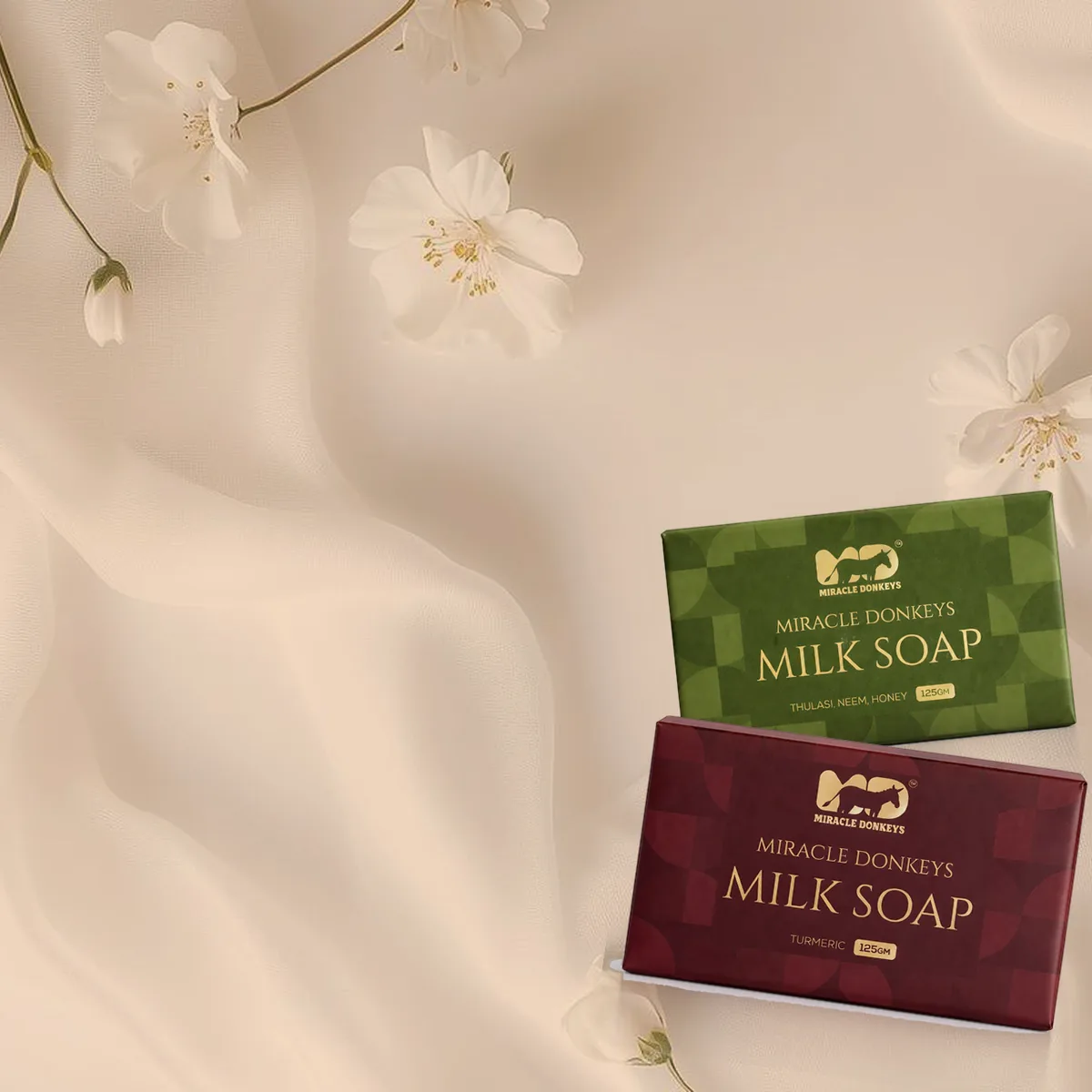 Turmeric and Thulasi donkey milk soap packs on peach silk with white flowers